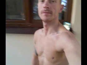 Fit guy is walking naked around his house and playing with his big cock
